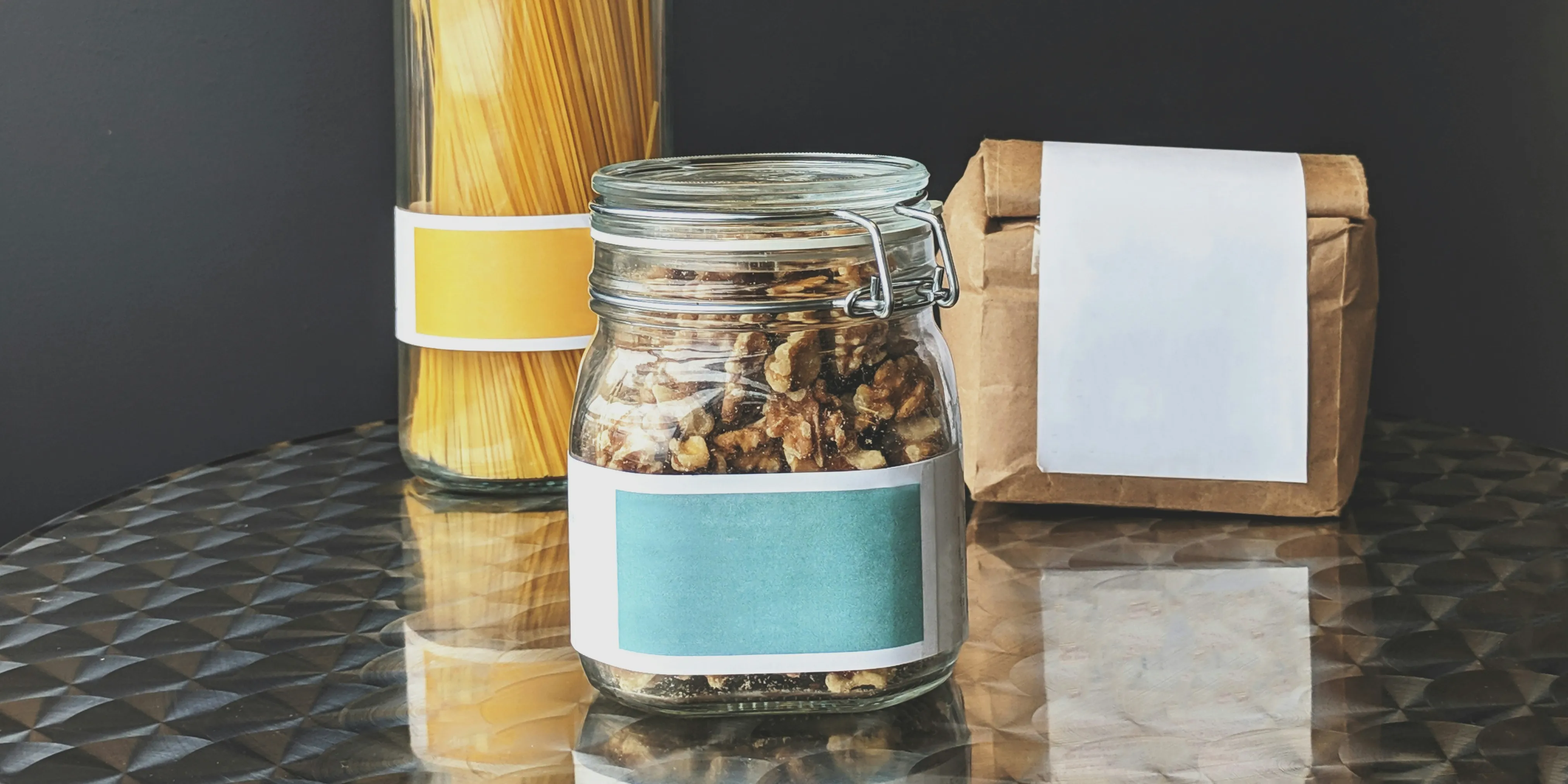Jars and a paper bag with blank labels, ready for a private brand